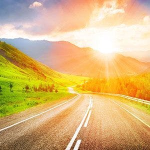 Open road with mountain sunrise view